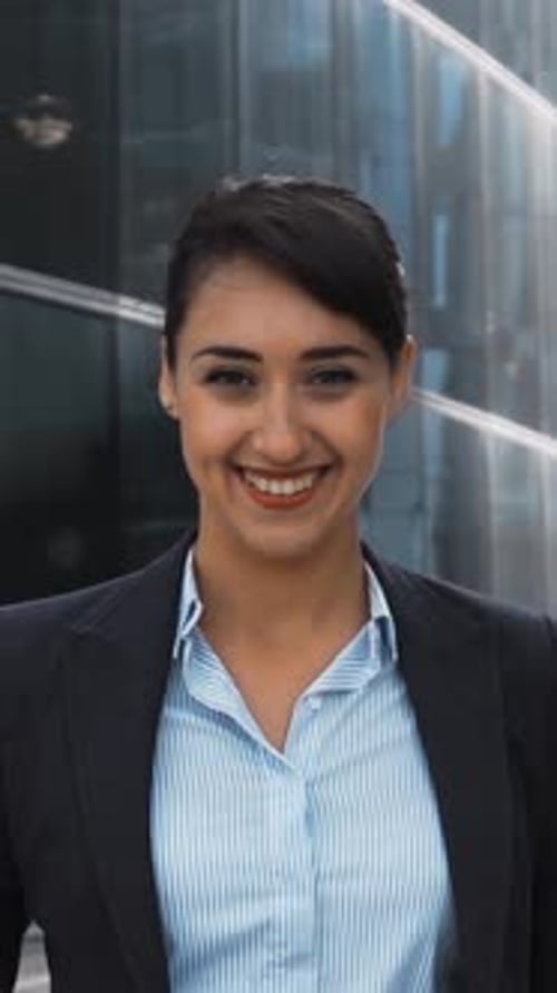 Smiling Young Businesswoman Posing Near Modern Building
