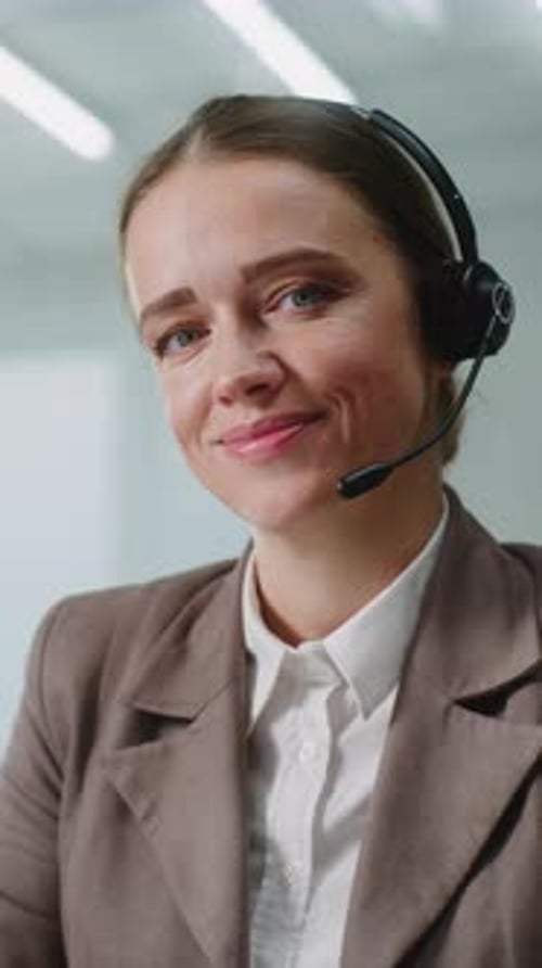 Friendly Woman Smiling Wearing a Headset in Office