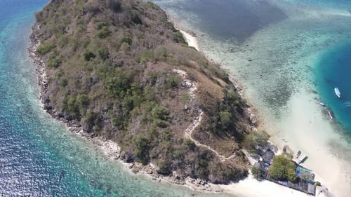 Aerial view of beaches and tourist boat sailing in Kelor Island, Flores Island, Indonesia.