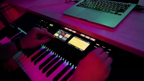 professional recording studio sound engineer or music producer musician pressing synthesizer keys