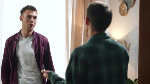 Two Young Men Talking at Home