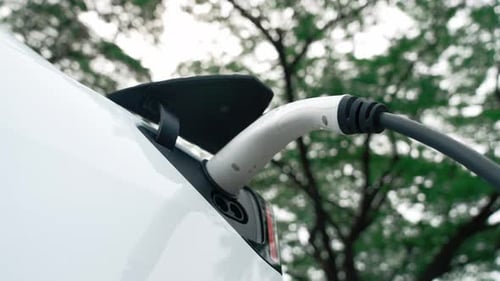 EV electric vehicle recharging battery in national park. Exalt