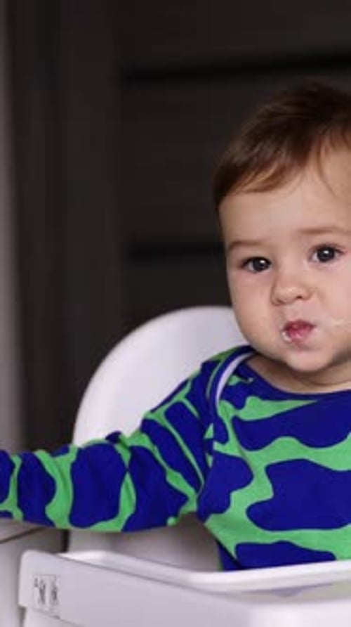 Adorable Baby in Highchair, Vertical Portrait