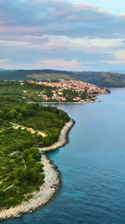 Aerial, drone view of buildings on the shore of the Adriatic sea in Croatia. Vertical