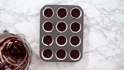 Flat Lay Baking Chocolate Cupcakes Scooping Chocolate Cupcake Batter Into a Cupcake Pan