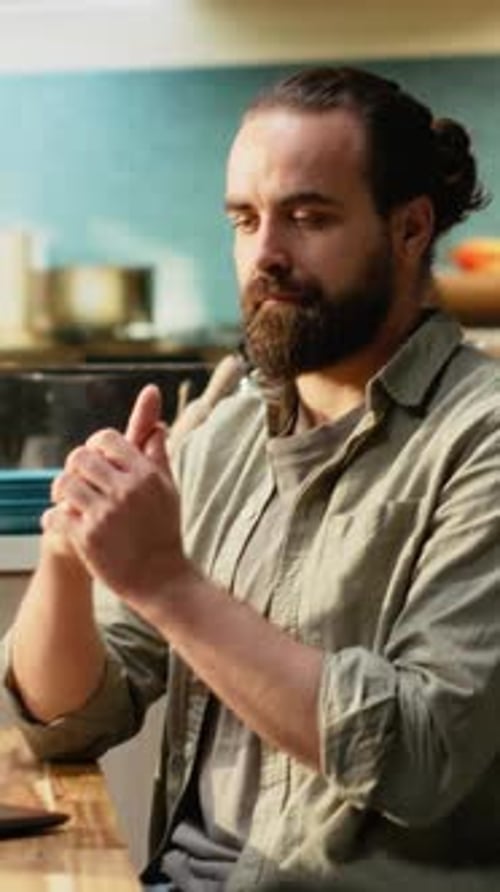 Vertical Video Adult Male Cracking His Knuckles Due to a Nervous Habit at Home