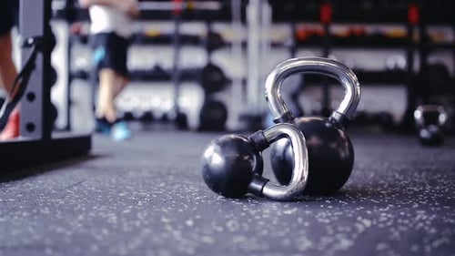 Pair of Kettlebells Laid on the Floor in Gym Activity
