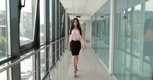 woman walks beautifully down the hall