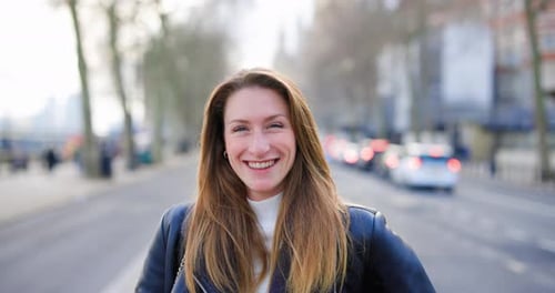 Beautiful smiling woman posing on a city street