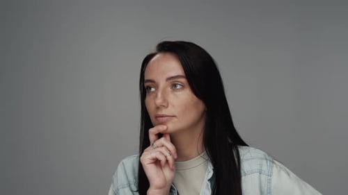 Portrait of Young Caucasian Woman Looking at Camera and Thinking on Solution