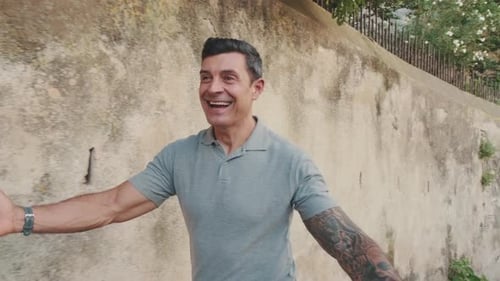 A happy father meets his daughter and hugs her on the street