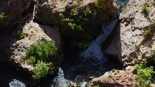 Aerial. Mountain river with waterfalls flowing into pools through granite rocks. serene valley with