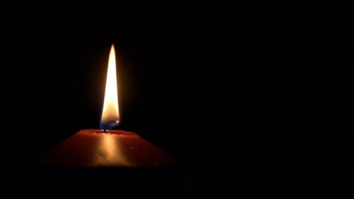 A close-up view of the luminous flame of a burning candle