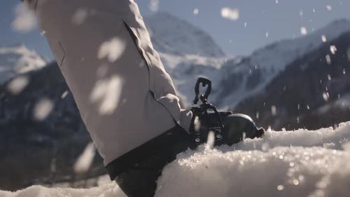 Skier Puts His Foot on the Snow Fastens the Clasp Adjusting Boat Buckle on Ski Boot Skiing