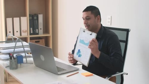 Man Presenting Business Data in Virtual Meeting
