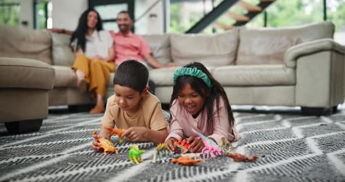 Children Playing Dinosaurs in Living Room with Parents