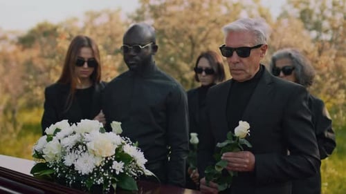 Mourners Gather around Coffin at Funeral