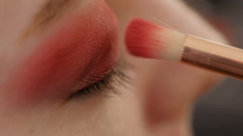 Makeup Artist Applying Eye Shadow Makeup to Model's Eye Close Up View Smoky Eyes Left View Slow