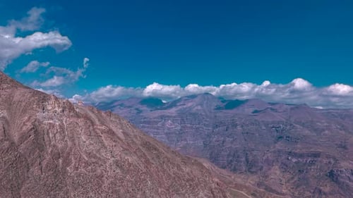 Breathtaking aerial drone flight over the rugged rocky terrain of the Andes Mountains near