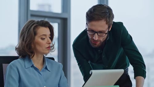 Businessman Showing Business Report to Woman Financial Manager in Office Closeup