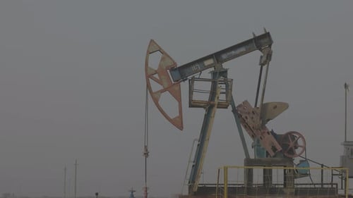 Oil Industry Pumping Petroleum Rig in Desert Pump Jack Extracting Crude Oil From a Oil Well Fossil