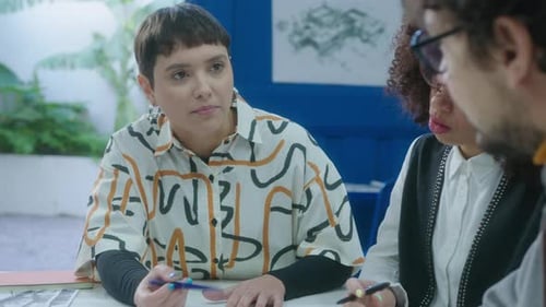 Colleagues Working Together on Architectural Project in Office