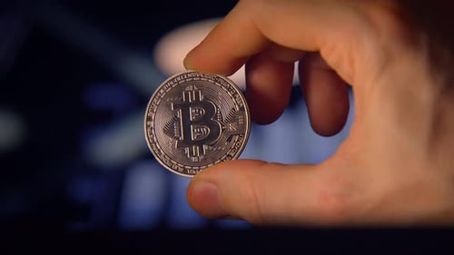 Holding Bitcoin Crypto Currency Close Up