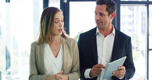 Confident Business Team Discussing Data on Tablet