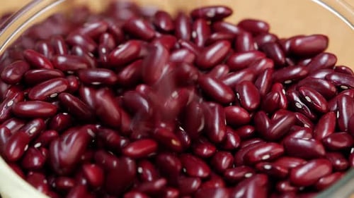 A pile of red beans on a wooden surface, table, and close up