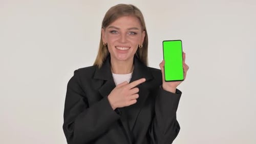 Portrait of Businesswoman Showing Smartphone with Green Screen on White Background