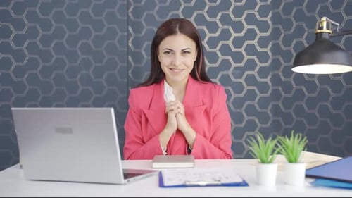 Smiling Woman at Her Desk in an Office