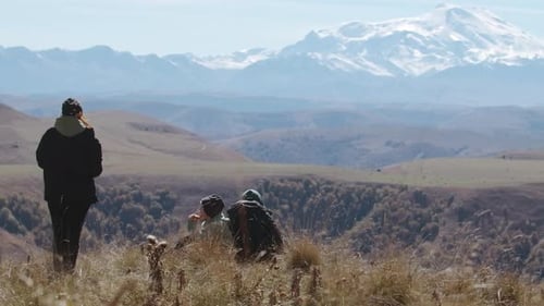 Family of tourists on a journey admire the view of the mountains