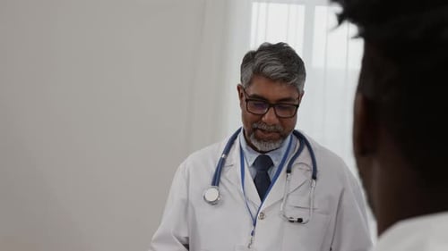 Team of Diverse Healthcare Workers Discussing Latest Studies in Their Field