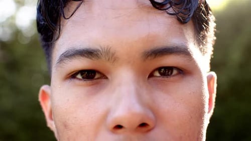 Close-up of man with focused expression outdoors