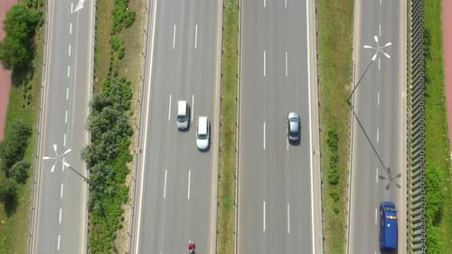 Top view of freay road. Clip. Highway with traffic in forest. Suburban highway with cars and trucks.