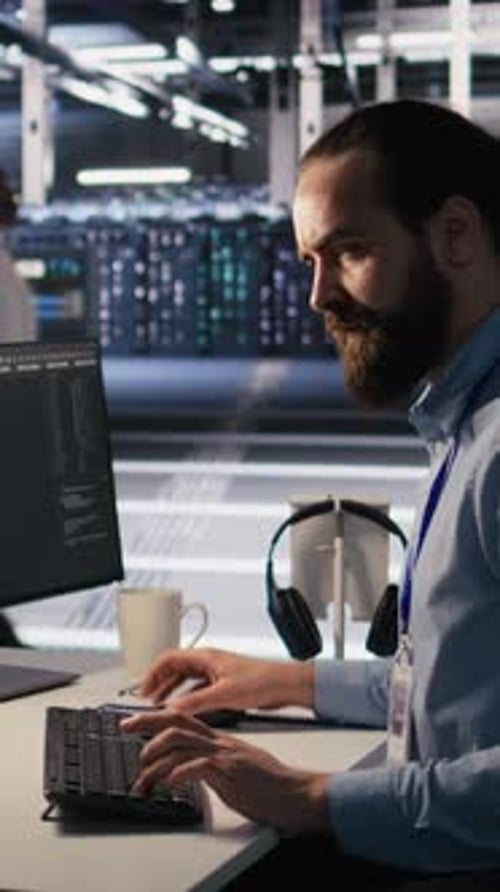 Vertical Video Exhausted Computer Scientist in Server Room Suffering From Mental Fatigue