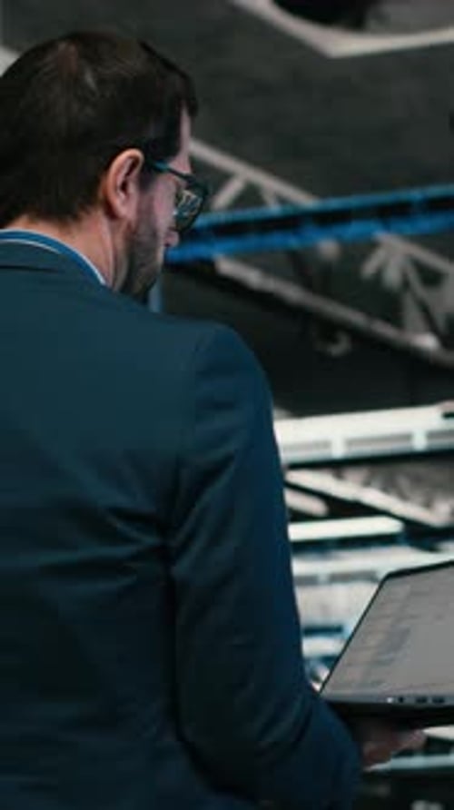 Vertical Video Software Developer in Data Center Using Laptop to Code