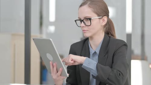 Professional Woman Using Tablet in Modern Office