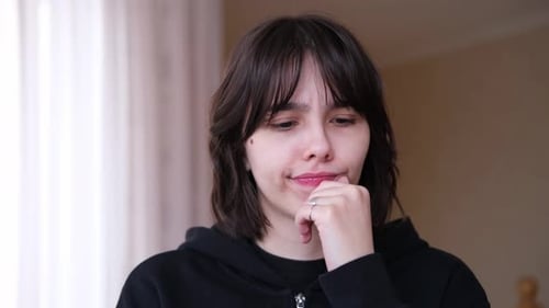 Pensive Young Adult Contemplating Indoors