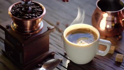 Coffee cup with freshly brewed coffee on an old vintage table.