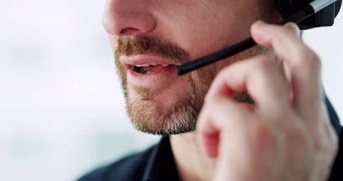 4k video footage of an unrecognizable male call center agent using a headset in his office