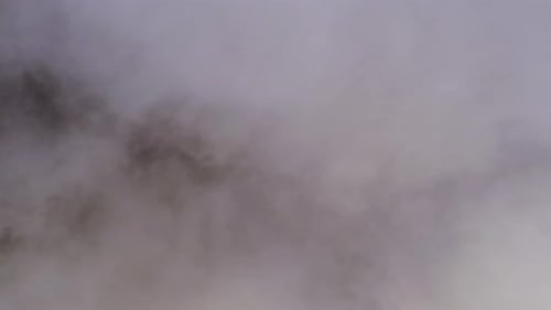 Aerial View of Dense Fog and Clouds Over Mountains