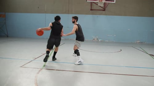 Athletes Compete In A One On One Game In Indoor Basketball Court