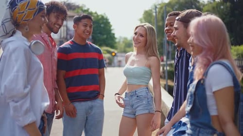 Friends Chatting Together Outdoors on Sunny Day
