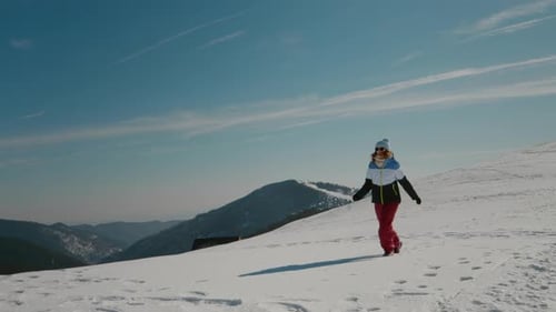 Landscape with mountains peak and woman trekking her route.