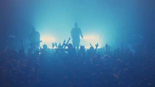 Energetic Rock Band Performing Live for Cheering Fans