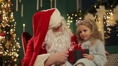 Santa Giving a Christmas Gift to a Girl