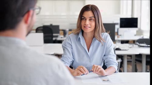 Smiling Woman Having Productive Meeting with Colleague