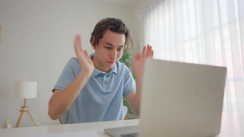 Tired Man Working on Laptop at Home