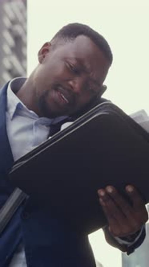 Clumsy, businessman and drop paper in city with phone call, coffee or multitasking on commute to